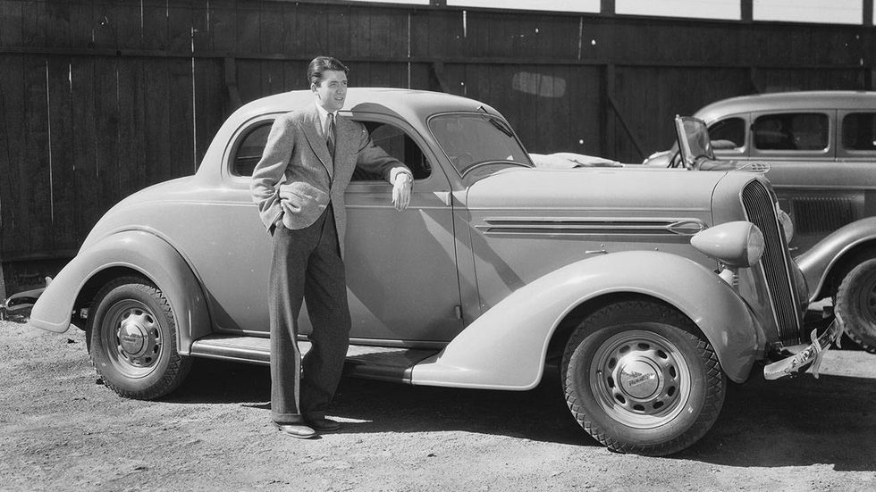 James Stewart American actor James Stewart (1908-1997) leaning against a 1936 Plymouth. April 1, 1936