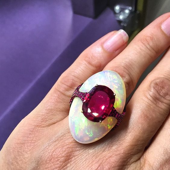 This one-of-a-kind Boghossian ring combines an impressive 27.24 carat opal and a 4.43 carat cushion-shape Siam ruby with ruby pavé band and details. 