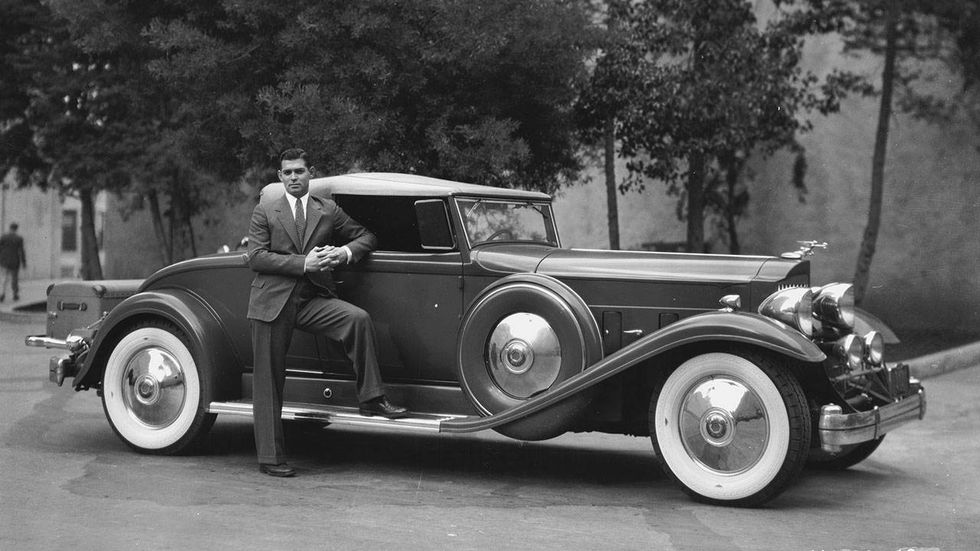 Clark Gable 24th April 1933: American screen star Clark Gable(1901-1960), who became known as the 'King of Hollywood', poses next to his luxurious 1932 Packard.